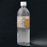 Beautiful Rustic Wood Barrel and Sunflowers Water Bottle Label<br><div class="desc">🥇AN ORIGINAL COPYRIGHT DESIGN by Donna Siegrist ONLY AVAILABLE ON ZAZZLE! Custom Wedding water bottle labels ready for you to personalize. Featured in a country barn wood setting with mason jars and string lights hanging over a bale of straw hay, a wagon wheel and beautiful yellow sunflowers. 📌If you need...</div>