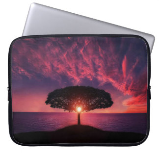 Beautiful scenery with the sun rising behind a tre laptop sleeve