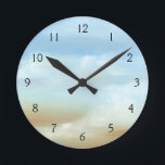 Beautiful Skyscape with Fluffy Clouds Round Clock<br><div class="desc">Doesn’t this skyscape just make you want to go outside and look up? Fluffy clouds float across a beautiful blue skyscape,  making it feel as if you are looking out of a plane window. Purchase a copy today!</div>