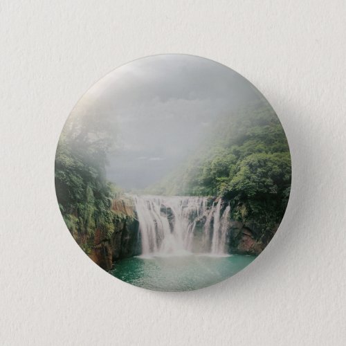 Beautiful Waterfall in a Lush Green Forest Button