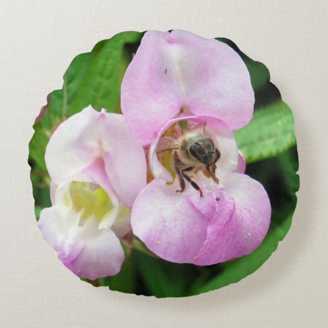 Bee emerging from a sweet pea flower round pillow (Front)