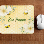 Bee Happy bumble bees yellow honeycomb summer Mouse Pad<br><div class="desc">Yellow,  white background with a honeycomb pattern. Decorated with light yellow,  cream colored tropical florals flowers,  hibiscus and happy bumble bees. The text: Bee Happy in green hand lettered style script. Perfect for your summer home work space,  office!</div>