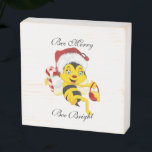 Bee Merry Christmas Cartoon Wooden Box Sign<br><div class="desc">Adorable Christmas bee cartoon with a Christmas red nose,  Christmas hat,  holding a peppermint candy cane and a red honey basket.
Cute kids' Christmas cartoon design.
Easy to personalize by changing the text.</div>