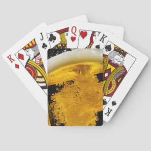 Beer been poured into glass poker cards
