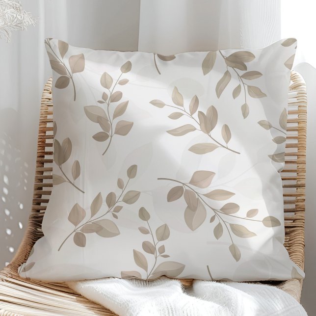 Beige and White Watercolor Leaves Throw Pillow (Beige and White Watercolor Leaves Throw Pillow in a sunny rattan armchair.)