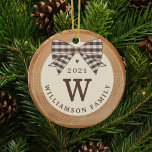 Beige Buffalo Plaid Bow Monogram Photo Wood Slice Ceramic Ornament<br><div class="desc">Add a rustic charm to your Christmas tree with our faux family monogram ornament featuring a rustic faux wood slice background decorated with a buffalo beige plaid bow. Customize with your family monogram, name and year. The reverse side features a place to add your family photo. Designed by Moodthology Papery...</div>