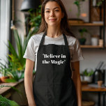 Believe in Magic Black and White  Apron<br><div class="desc">Add a touch of elegance and charm to your holiday cooking with the "Believe in Magic" black and white apron. This minimalist design features a stylish black and white color palette with an inspiring "Believe in Magic" message, making it the perfect addition to your Christmas kitchen attire. Whether you're preparing...</div>