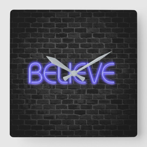 Believe text in neon lighting on brick square wall clock
