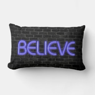 Believe text in neon lights on brick lumbar pillow