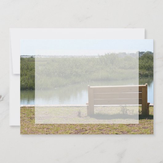Bench by river with grass and water (Front)