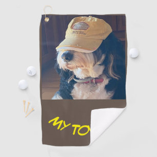 Bernedoodle dog in yellow golf cap photo towel