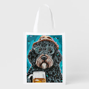 Bernedoodle holding a beer mug grocery bag