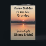 Best Grandpa Light Shines Bright Birthday Card<br><div class="desc">Express your wishes to your grandpa for a happy day on an inspirational sunset birthday card with the verse “Your Light Shines Bright”. The minimal design is modern with bold colors of gold and black showing glowing water and a peaceful lake.</div>