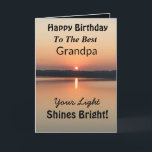 Best Grandpa Light Shines Bright Birthday Card<br><div class="desc">Express your wishes to your grandpa for a happy day on an inspirational sunset birthday card with the verse “Your Light Shines Bright”. The minimal design is modern with bold colors of gold and black showing glowing water and a peaceful lake.</div>