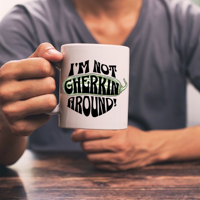 Big Dill- Green I'm Not Gherkin Around Pickle Pun Coffee Mug (Man wearing a grey shirt holding an I'm not Gherkin Around mug.)
