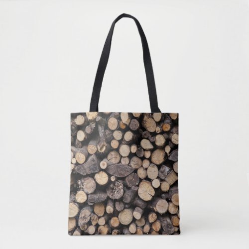 Big pile of sawn logs stacked on top of each other tote bag