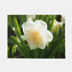 Big white daffodils on a spring day doormat