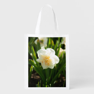 Big white daffodils on a spring day grocery bag
