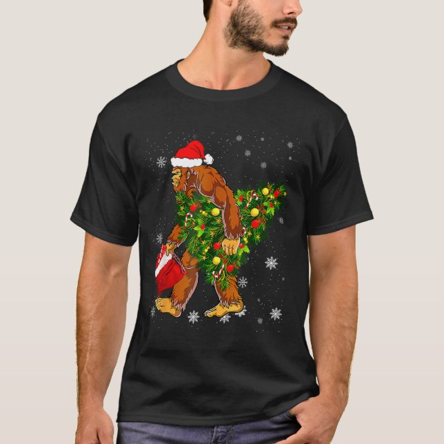 Bigfoot Carrying Christmas Tree Sasquatch Believer T-Shirt (Front)