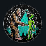 Bigfoot Meets Alien Dart Board<br><div class="desc">This whimsical image illustrates a friendly encounter between two legendary beings: Bigfoot and an alien. The scene, set against a starry night sky with silhouettes of pine trees, shows Bigfoot and the alien shaking hands under the beam of a UFO hovering above. Bigfoot, covered in brown fur, stands on the...</div>