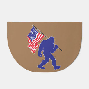 Biigfoot carrying an American Flag Doormat