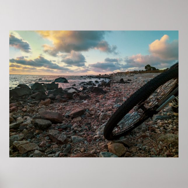 Bike parked at rocky beach poster (Front)