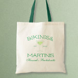Bikinis & Martinis Green Beach Bachelorette Party Tote Bag<br><div class="desc">Make your bachelorette party unforgettable with our "Bikinis and Martinis" Bachelorette Tote Bag! Perfect for a beach bachelorette or girls' weekend, this stylish tote features vibrant green tones and a chic martini glass design. Personalize it with the bride's name for a special touch. Whether you're packing beach essentials, party favors,...</div>