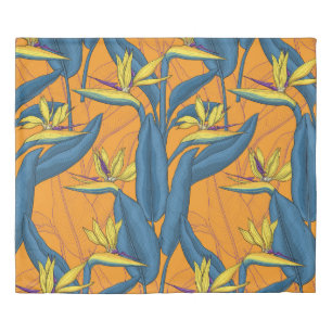 Bird of paradise flowers on orange duvet cover