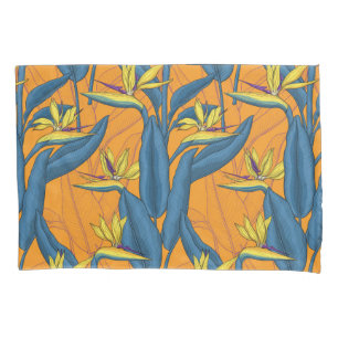 Bird of paradise flowers on orange pillow case