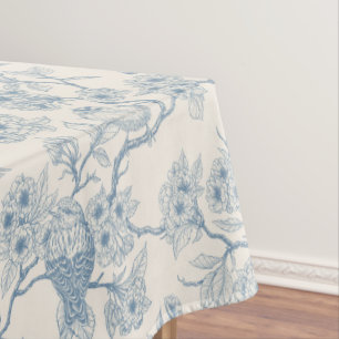 Birds and cherry blossom in blue and off white tablecloth
