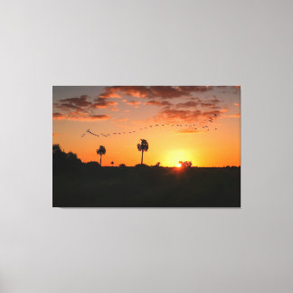 Birds crossing at sunset canvas print