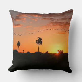 Birds crossing at sunset throw pillow