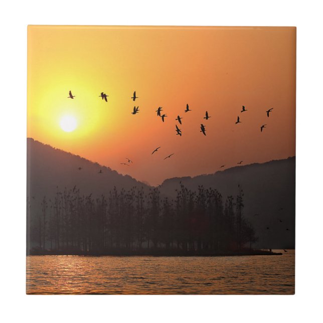 Birds Flying in Sunset Sky Over East Lake Ceramic Tile (Front)