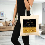Birthday black gold monogram elegant tote bag<br><div class="desc">Elegant,  classic,  glamorous and feminine.  A gold colored bow with golden glitter and sparkle,  a bit of bling and luxury for a 21st birthday.  Black background. Templates for her name,  age 21,  date of birth and anniversary date.</div>