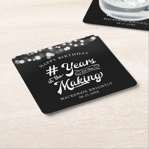 Birthday String Light YEARS IN THE MAKING Square Paper Coaster - Celebrate any age birthday for him or her with these personalized black and white paper coasters featuring a calligraphy script typography title design # YEARS IN THE MAKING that incorporates their age and birth year within the design, the editable title HAPPY BIRTHDAY and name and date or other custom text with a border of string lights. Contact the designer via Zazzle Chat or makeitaboutyoustore@gmail.com if you'd like this design modified, in another color, on another product or would like coordinating items.