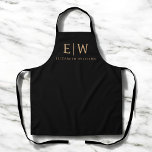 Black and Gold Minimalist Modern Monogram Apron<br><div class="desc">Cook, create, or craft in style with this Black and Gold Minimalist Modern Monogram Apron. Featuring a sleek black fabric and a bold faux gold monogram, this apron combines everyday function with elevated design. Perfect for chefs, bakers, artists, or anyone who loves a personalized touch, it includes adjustable straps and...</div>