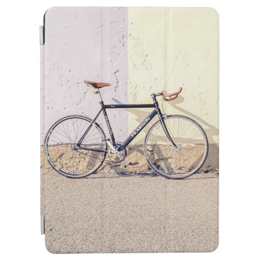 BLACK AND GRAY CITY BIKE LEANING ON WHITE WALL iPad AIR COVER