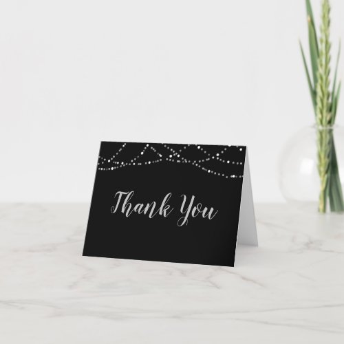 Black and Silver String Lights Thank You Card - Black thank you notecards with a silver and white string lights border and chic handwritten script type for the THANK YOU. The inside is blank to hand write your personal notes of appreciation.
Contact the designer if you'd like this design modified or on another product.