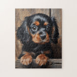 Black and tan Cavalier puppy Jigsaw Puzzle<br><div class="desc">The image depicts Cavalier King Charles Spaniel puppy with black and tan fur. Cavie is sitting in a row, looking directly at the viewer. The puppy have large, expressive eyes and fluffy ears. The background is a soft, blurred brown, creating a warm and inviting atmosphere. The painting style is realistic,...</div>