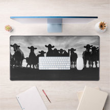 Black and White Cows Along Fence