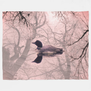 Black and white loon on a lake throw blanket pink