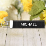 Black And White Simple Personalized Custom Text Wrist Keychain<br><div class="desc">Add your own text and easily create your personalized wrist keychain. Click CUSTOMIZE FURTHER to change the background color or text color. You can TRANSFER this DESIGN on other Zazzle products and adjust it to fit most of the Zazzle items. Standard Studio designs are made in high-resolution vector graphics for...</div>