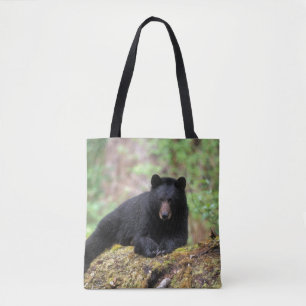 Black bear on an old growth log in the tote bag
