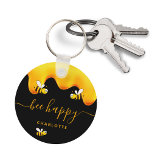 Black bee happy bumble bees sweet honey monogram keychain<br><div class="desc">A chic black background decorated with golden dripping honey. The text: Bee Happy with a golden hand lettered style script with swashes.  Personalize and add your name,  family name.</div>