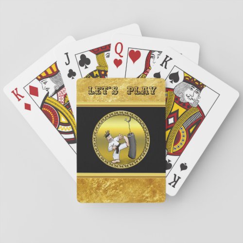 Black belt karate man kicking a black training bag playing cards