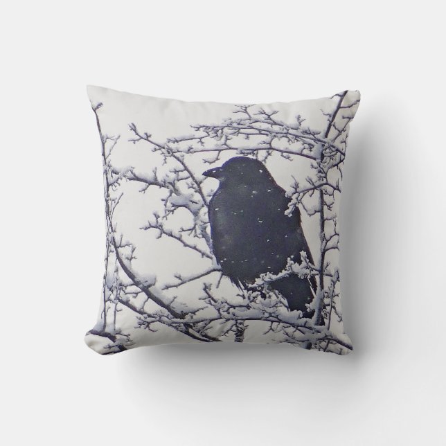 Black bird between snowy branches throw pillow (Front)