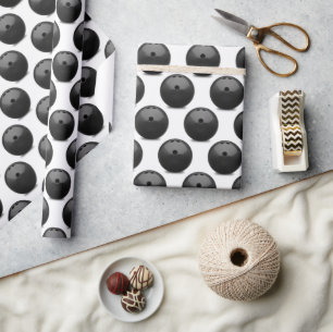 black bowling ball on white wrapping paper