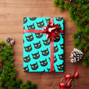 Black cat with green eyes on turquoise blue wrapping paper
