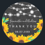 black chalkboard string lights sunflower Thank you Classic Round Sticker<br><div class="desc">Rustic black chalkboard,  string lights sunflowers wedding thank you with hand painted orange and green floral sunflowers arrangement on a vintage black chalkboard and an elegant calligraphy typography. Perfect for fall autumn weddings. Perfect for country ,  barn wedding themes.</div>