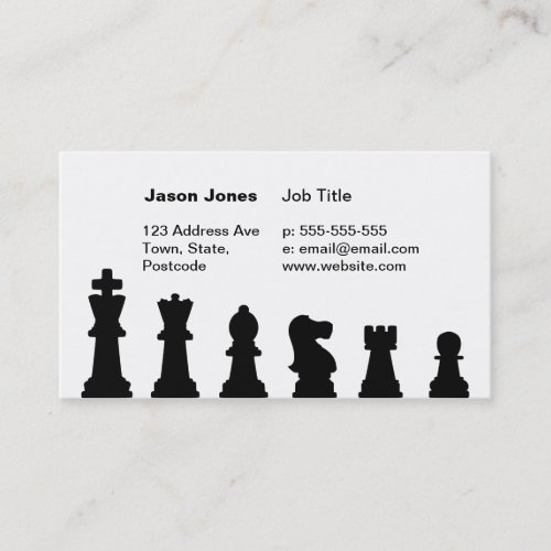 Black chess pieces on white business cards